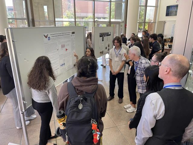 Students in front of poster