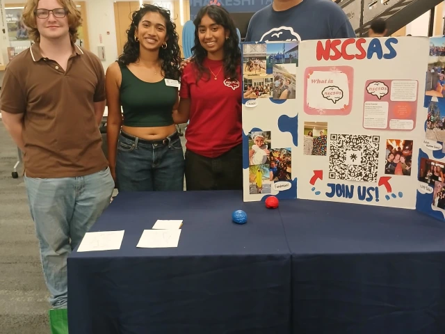 4 students behind their event table