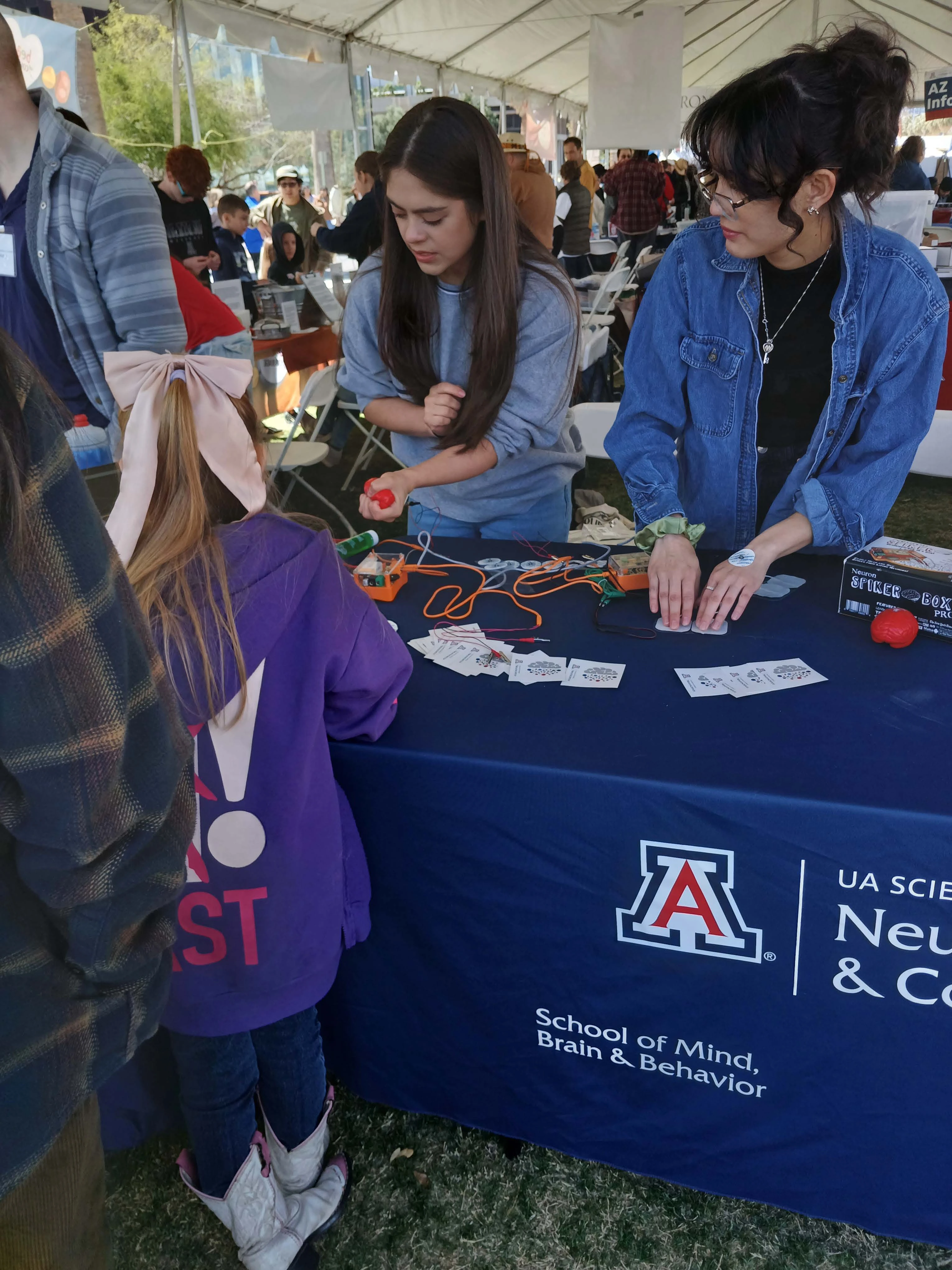 Undergraduate Students at Science city interacting with young child