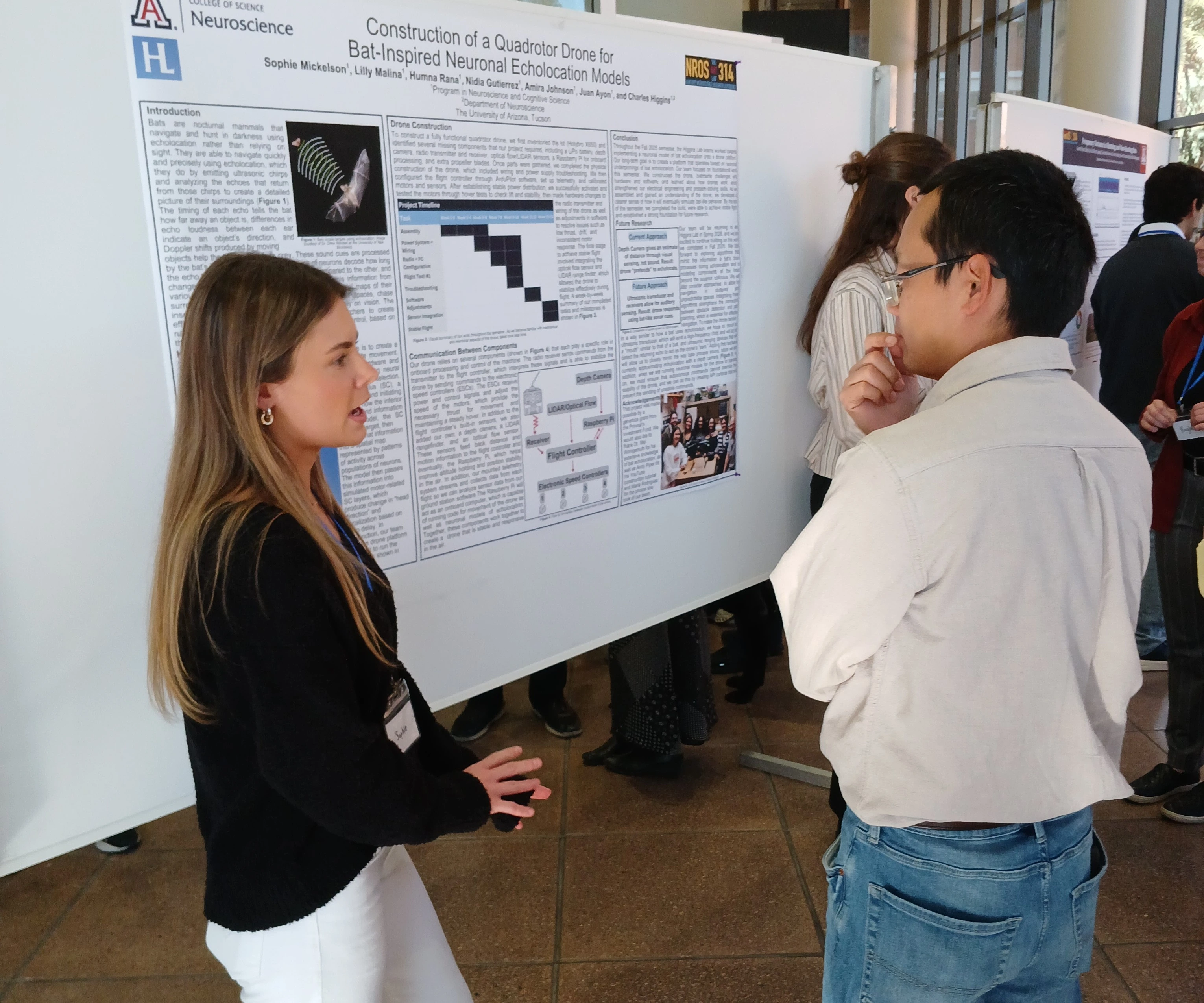 two people with poster